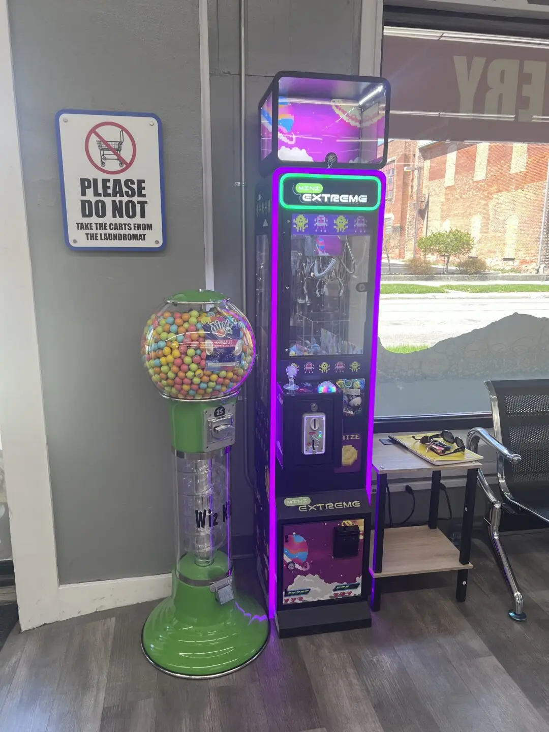 Gumball machine and claw machine inside Uptown Laundry near front door