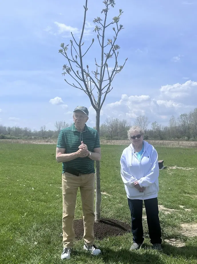 Arbor Day tree planting ceremony in Crestline honoring the memory of Tom Garrett with a Buckeye tree dedication.
