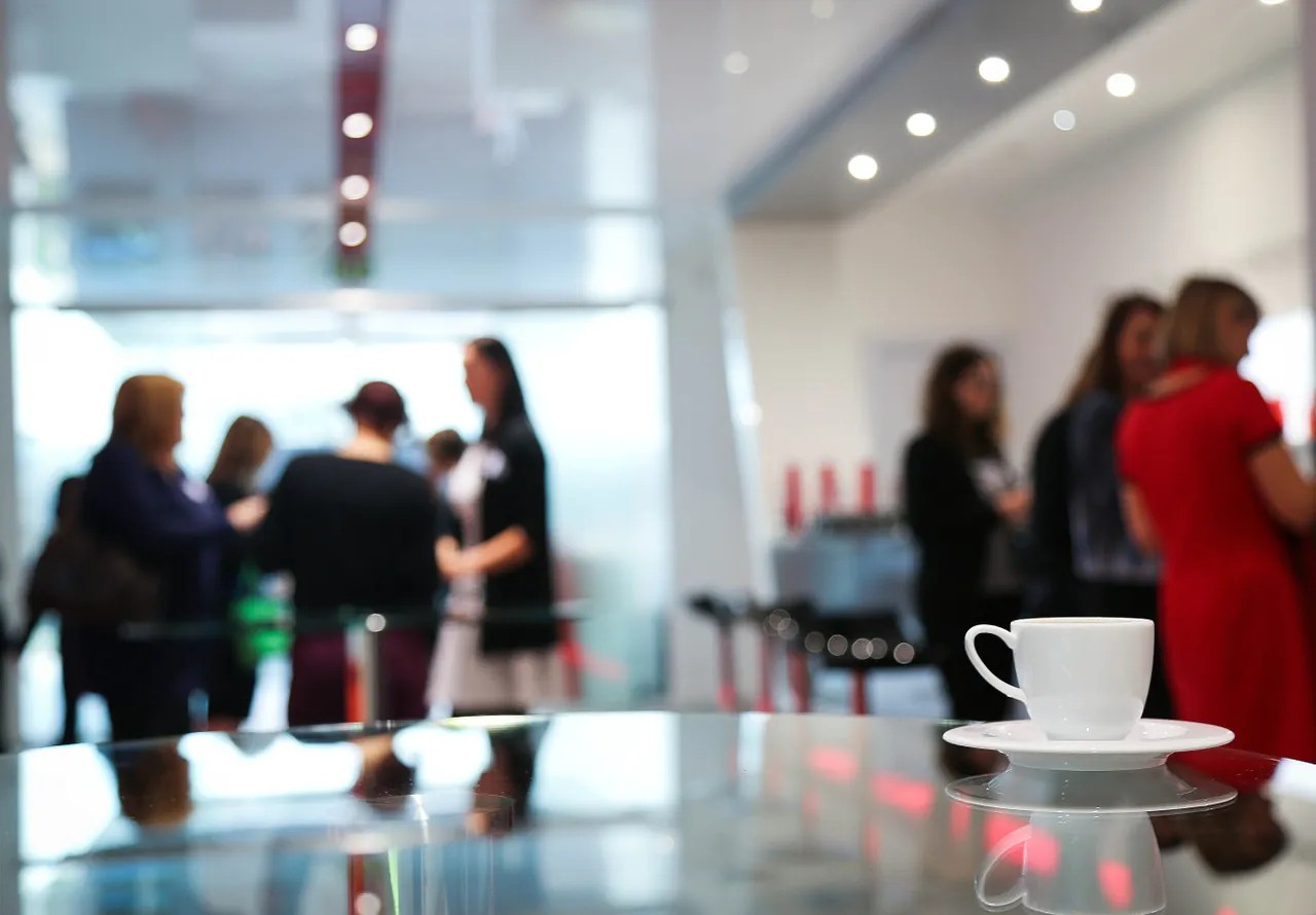 Chamber networking event with members socializing at a coffee shop.
